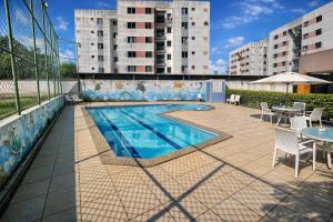 a swimming pool on the roof of a building at Cantinho da Aruana, conforto e tranquilidade in Aracaju