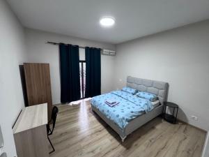a bedroom with a bed and a wooden floor at Hostel Villa EFES Private Rooms in Tirana