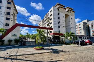 a street with tall buildings and a red sculpture at Cantinho da Aruana, conforto e tranquilidade in Aracaju