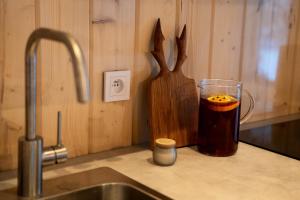 a kitchen counter with a cup of tea next to a sink at Siedlisko Gruszeczki in Gruszki +69 photos
