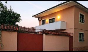 a house with a gate and a fence at Hostel Villa EFES Private Rooms in Tirana