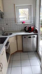 a small kitchen with a sink and a window at A&M Wohnen2 in Ravensburg