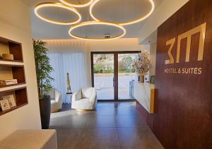 a lobby with a hotel and suites sign on the wall at 3M Hostel & Suites in Alvaiázere