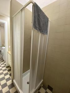 a shower with a glass door in a bathroom at Viva Accomodation in Bergamo
