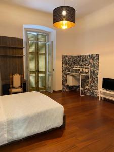 a bedroom with a bed and a desk and a television at Viva Accomodation in Bergamo