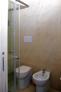 a bathroom with a toilet and a shower and a sink at Dimora Borbonica 1 in Marcianise