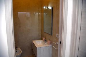 a bathroom with a sink and a toilet at Dimora Borbonica 1 in Marcianise