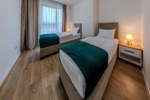 a hotel room with two beds and a window at Hotel MM Residence in Mostar
