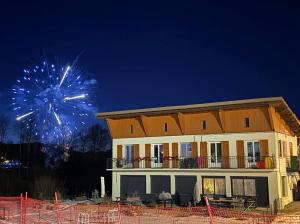 a building with a fireworks display in the background at Lodge des Mélèzes in Ancelle