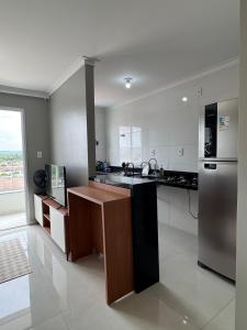 a kitchen with a sink and a refrigerator at Apartamento confortável em Santarém in Santarém