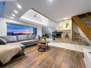 a living room with a couch and a fireplace at Sky Loft Schwarzach in Schwarzenbruck