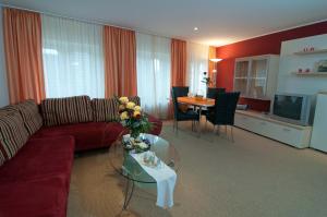 a living room with a couch and a table at Haus Siegfried Appartements in Xanten