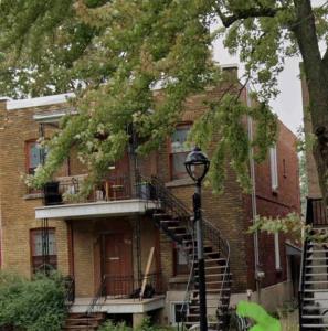 a brick building with a staircase in front of it at Studio moderne et tranquille in Montreal