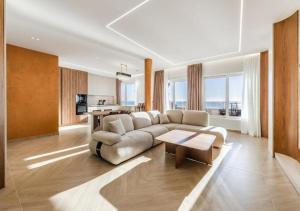a living room with a couch and a table at The Ultimate Jacuzzi Penthouse by PS in Durrës
