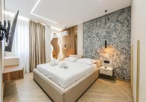 a bedroom with a large white bed in a room at The Ultimate Jacuzzi Penthouse by PS in Durrës