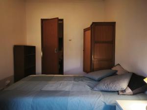 a bedroom with a bed with two pillows on it at Amadora Pet Apartment in Amadora