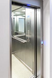 an elevator in a building with a glass door at Hotel MM Residence in Mostar +77 photos