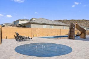 a swimming pool with a water slide and a playground at Splash and Putt Paradise home in Washington