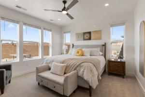 a bedroom with a bed and a chair and windows at Splash and Putt Paradise home in Washington
