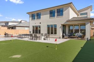a house with a yard with a putting green at Splash and Putt Paradise home in Washington