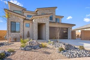 a house with a garage and rocks at Splash and Putt Paradise home in Washington +46 photos