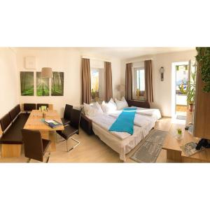 a living room with a bed and a table at Apartment Haus Braumandl in Bad Ischl