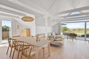 a living room with a table and chairs at Holiday Home Overlooking Ebeltoft Bay in Ebeltoft