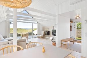 a living room with a couch and a table at Holiday Home Overlooking Ebeltoft Bay in Ebeltoft