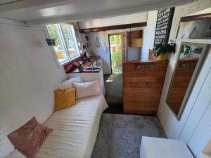 a small living room with a couch in a tiny house at Surf Shack on Broadway in Waitara
