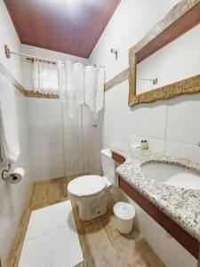 a bathroom with a toilet and a sink and a mirror at Mirante de Lençóis in Lençóis +67 photos