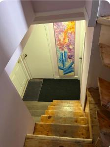 a view of a staircase with a painting on the wall at Studio moderne et tranquille in Montreal +1 photo