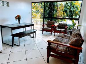 a living room with a couch and a table at Refúgio até 8 pessoas Churrasqueira e pátio cercado in Arroio do Meio