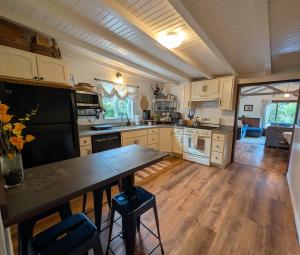 a kitchen with a large wooden table in a room at Sal's Beach Cottage Retreat in Fort Bragg