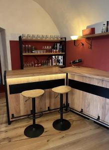 a bar with two stools in a room at Schloss1611 B&B in Erbendorf