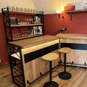a bar with two stools in a room at Schloss1611 B&B in Erbendorf +13 photos