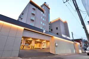 a hotel building with a building in a city at Hotel Coolstay Gimcheon in Gimcheon