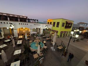 an outdoor restaurant with tables and chairs in a courtyard at Atlantic Breeze House I Double Rooms at EL CAMPANARIO I 5 minutes from Popcorn Beach in Corralejo