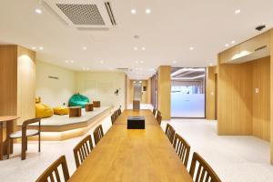 a conference room with a long table and chairs at Hotel Coolstay Gimcheon in Gimcheon