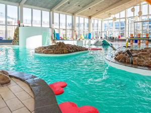a water park with a pool with rocks in the water at 4 person holiday home in Ringkøbing-By Traum in Ringkøbing