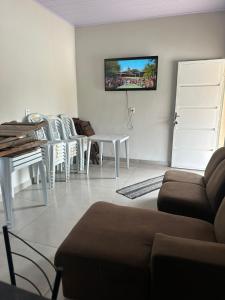 a living room with a couch and a table at Rancho Patrocínio in Patrocínio +8 photos