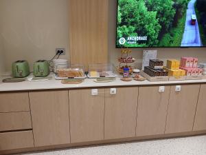 a buffet with cakes and desserts on a counter at Hotel Coolstay Gimcheon in Gimcheon