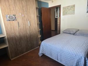 a bedroom with a bed and a large wooden cabinet at Premium house with pool in Santana do Livramento +57 photos