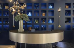 a table with a vase on it in a room at The Posthouse Berlin Potsdamer Platz- Leonardo Limited Edition in Berlin