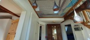 a room with a ceiling with some lights on it at Cosy Eco-Loft in Pettingen