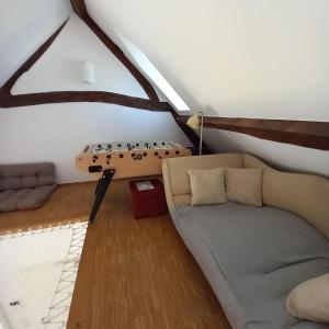 a living room with a couch and a table at Cosy Eco-Loft in Pettingen