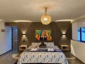 a bedroom with a large bed with a painting on the wall at La Marteja in Salento