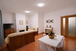 a living room with a couch and a table at Casa do Paraíso in Elvas