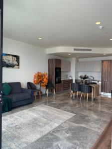 a living room with a couch and a table at Whispering Waves at Mercury Tower with panoramic view , 2X pools and Gym in Paceville