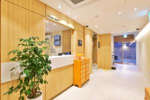 a bathroom with wooden walls and a potted plant at Hotel Coolstay Gimcheon in Gimcheon