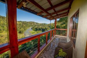 a balcony of a house with a view of a river at Villa azul círculo auto in Jarabacoa
